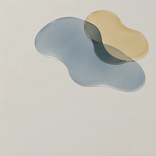 Two overlapping translucent, irregular blue-grey and amber forms with glossy highlighted edges sit across the upper half of a warm light-grey square field…