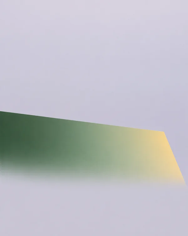 A large green-to-gold geometric form crosses the lower half of a pale grey-lilac portrait background, with ample empty space above.