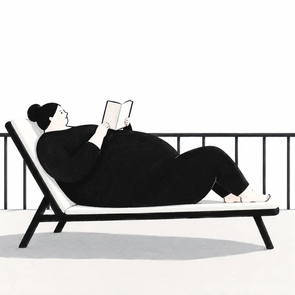 A large, dark-clothed person reclines on a white-cushioned black lounge chair, holding an open book above their belly.