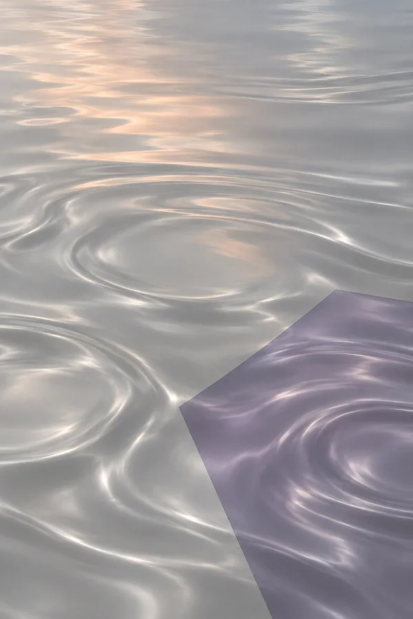 An overhead abstract view of pearl-grey liquid with soft peach reflections and broad ripples; a sharply bounded muted-violet polygon in the lower-right…