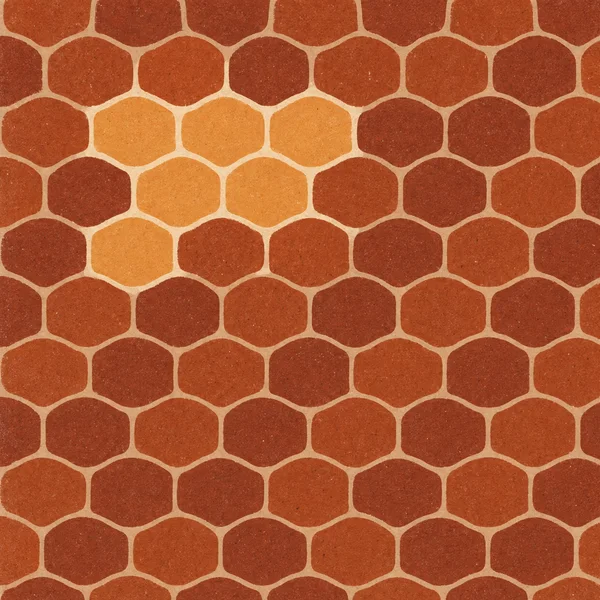 A full-frame repeat pattern of rounded, staggered rust and burnt-orange tiles, with a small group of lighter apricot tiles near the upper-left centre and pale…