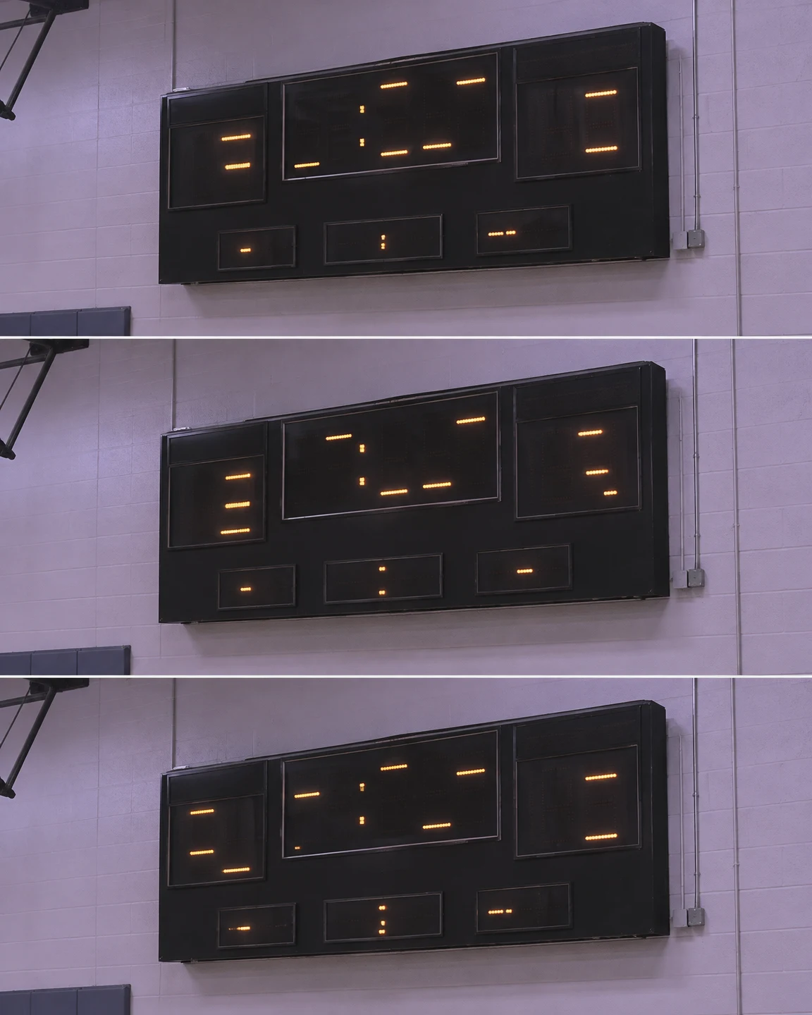 Three stacked views show the same black wall-mounted electronic scoreboard against a pale lavender gym wall, with sparse amber LED segments in different…