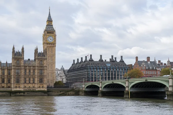 Elizabeth Tower and part of the Palace of Westminster rise on the left, with Westminster Bridge crossing the Thames in front of buildings on the opposite bank…