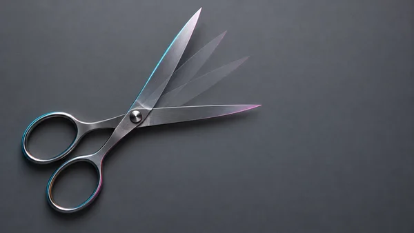 A pair of polished steel scissors lies open on a matte slate-gray surface, with faint overlapping blade positions sweeping upward from the pivot and broad…