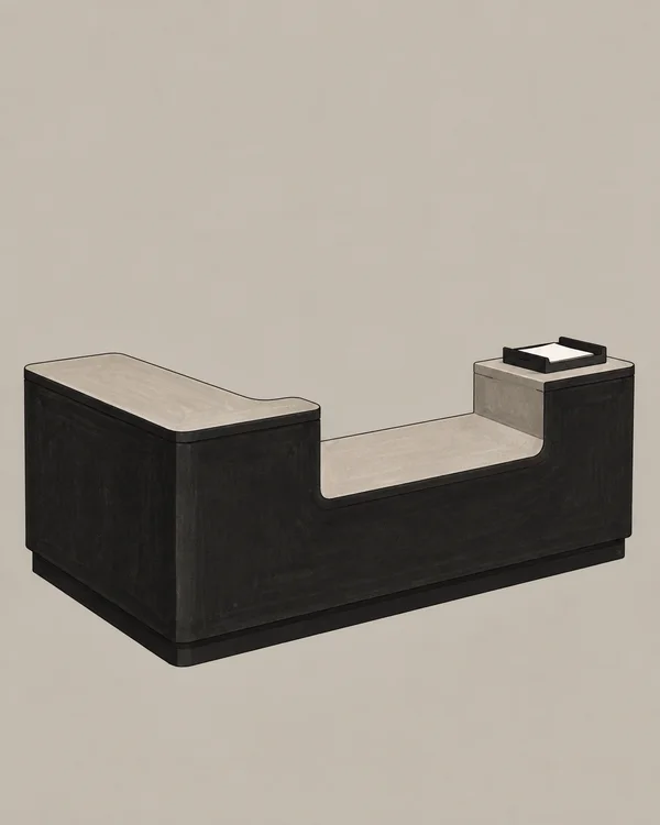 A broad, dark counter with a large warm-gray service opening stands against a plain warm-gray background; a shallow tray holding a blank sheet sits on the…