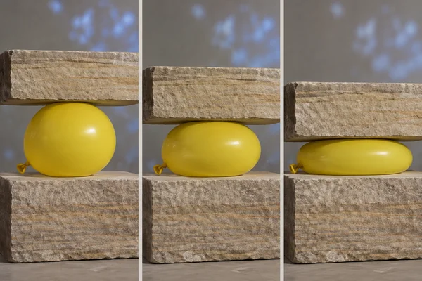 A three-panel studio sequence shows a yellow balloon beneath a sandstone slab, progressing from nearly round to moderately compressed to flattened while…