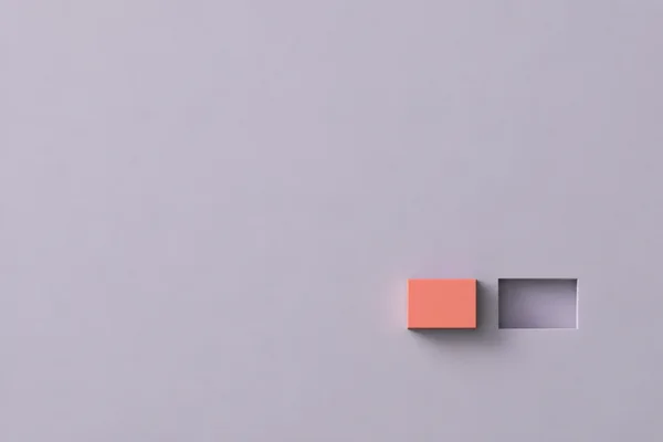 A small coral rectangular tile and a shallow rectangular recess sit side by side in the lower-right area of a pale lavender-grey field, with soft shadows…