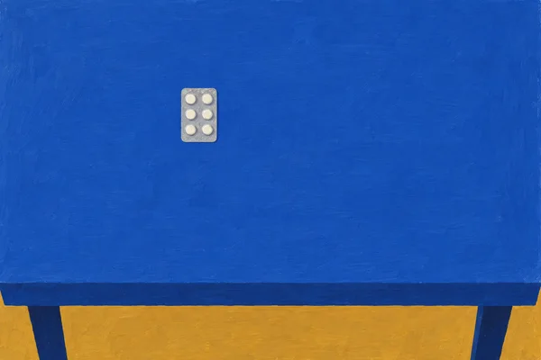 A small silver blister pack with six ivory tablets sits on a broad cobalt-blue table, above a wide ochre area with dark blue supports visible below the table…